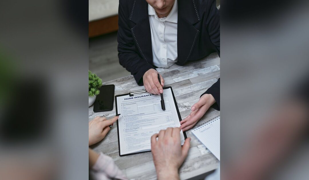 Public adjuster reviewing an insurance claim with Florida homeowners at a table